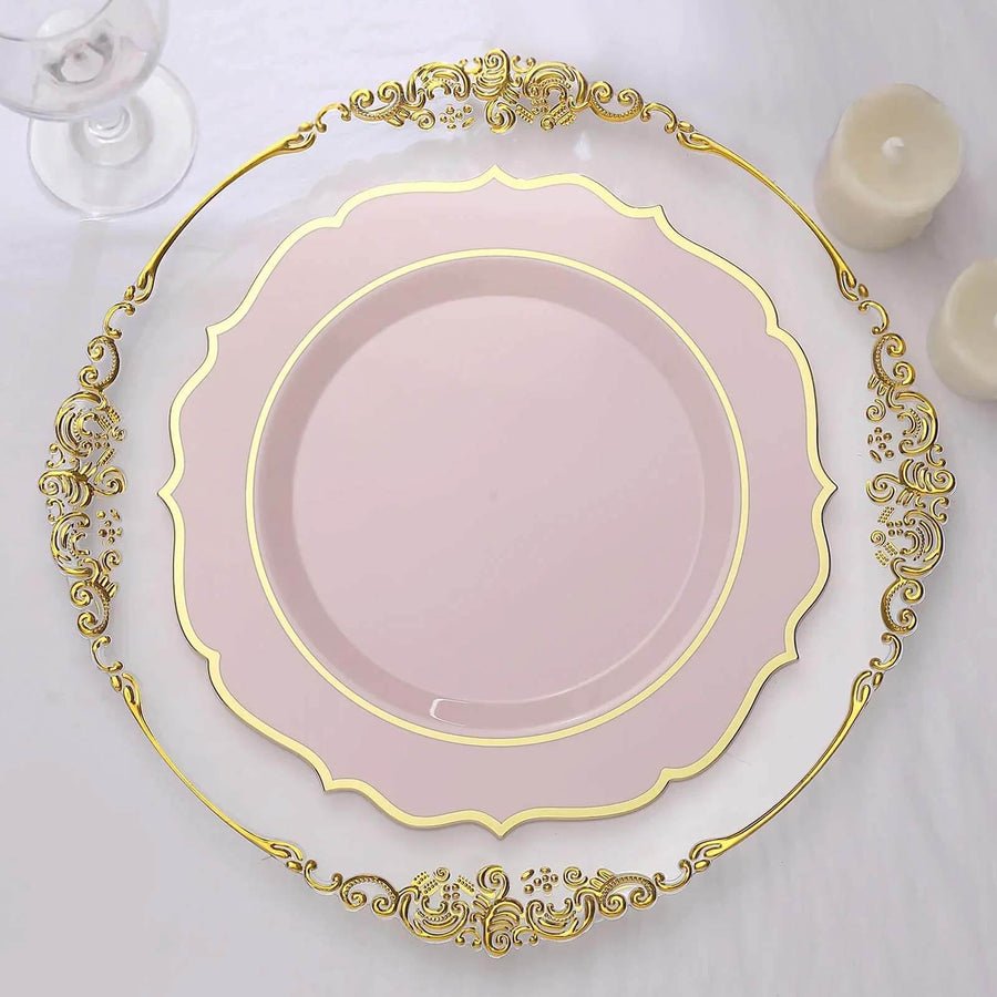 Light pink plastic dinner plate with gold rim on ornate charger – luxury disposable wedding tableware