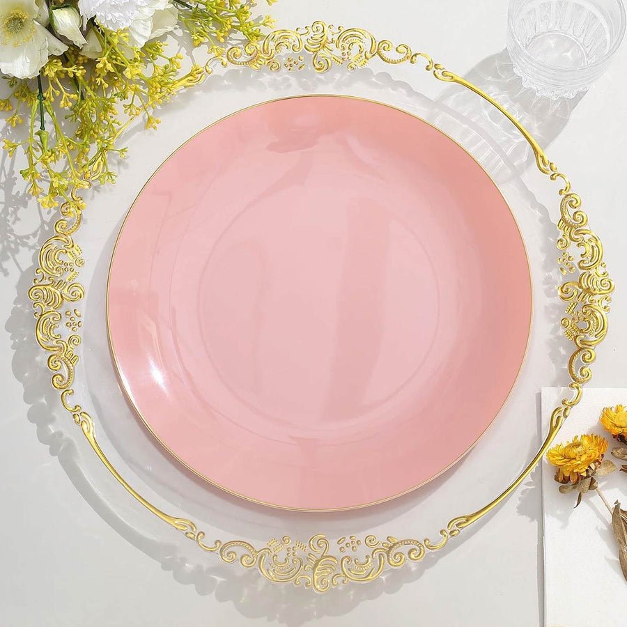 Clear baroque charger plate with ornate gold rim, set with elegant navy blue plates. Disposable wedding tableware.