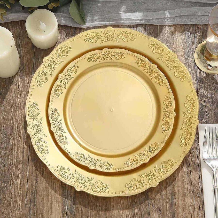 Clear plastic dinner plate with ornate gold baroque rim. Disposable elegant wedding tableware.