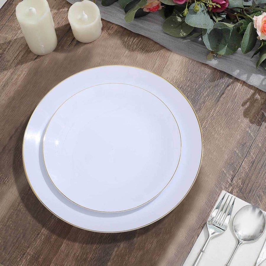 Stack of white plastic disposable plates with gold rim. Elegant tableware for weddings & parties.