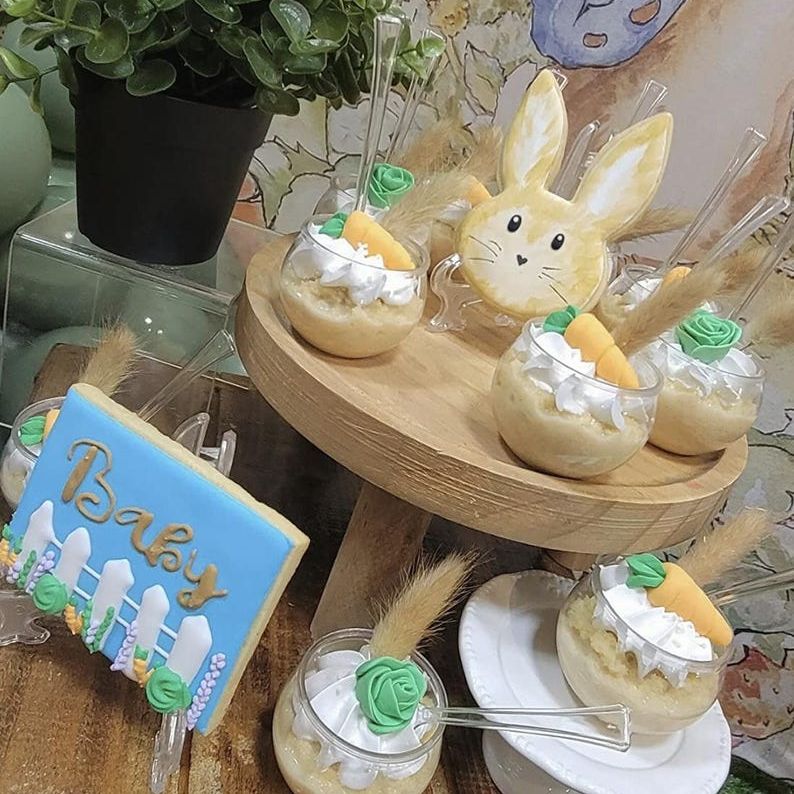 Tiered dessert display with acrylic bowls at a baby shower table