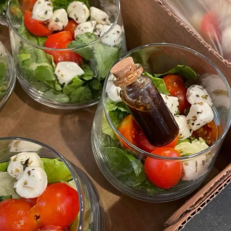 Clear acrylic salad cups with mini cork bottle and fork