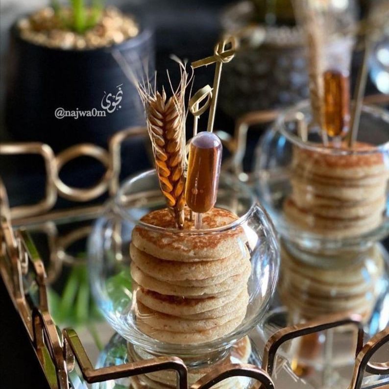 Acrylic sphere appetizer cup with mini pancakes and heart-shaped pipette
