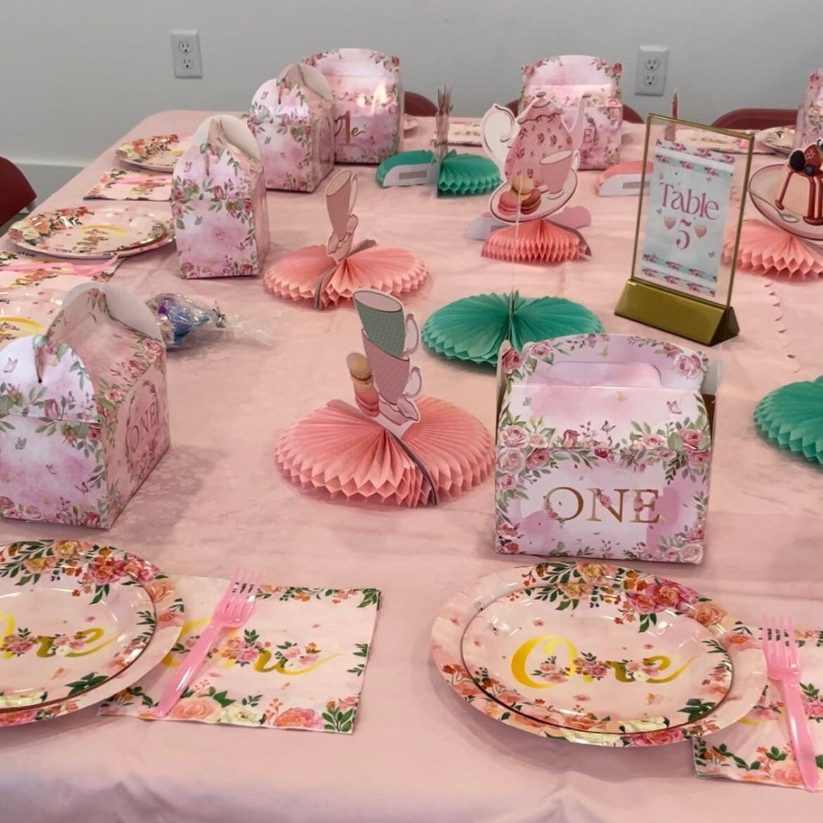 Baby girl 1st birthday theme napkins with gold lettering and pink plastic forks