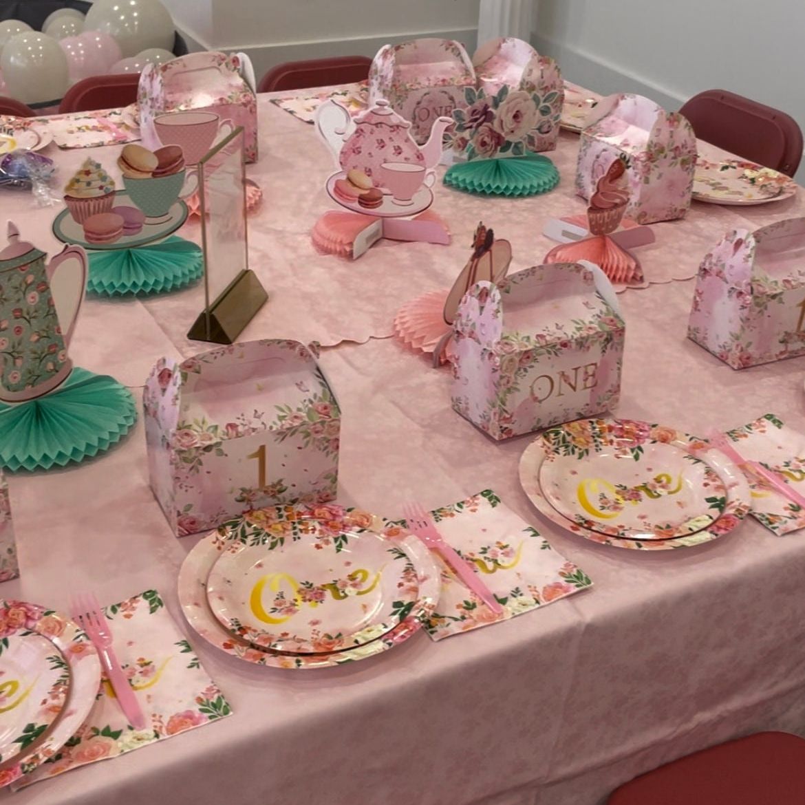 Baby girl first birthday plates showing elegant floral design and gold ONE text