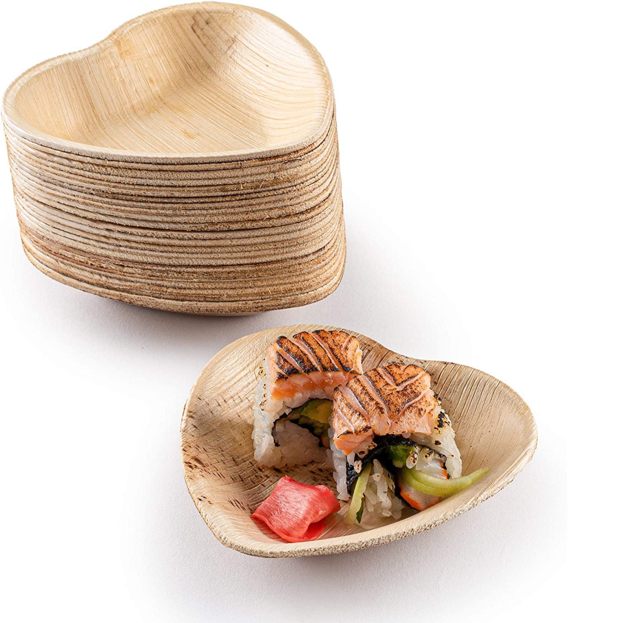 Close-up of heart-shaped bamboo plate with desserts and pink heart toothpicks
