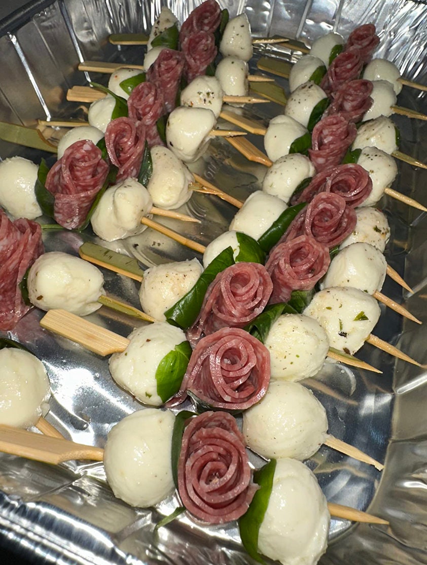 Mozzarella and salami skewered on bamboo toothpicks