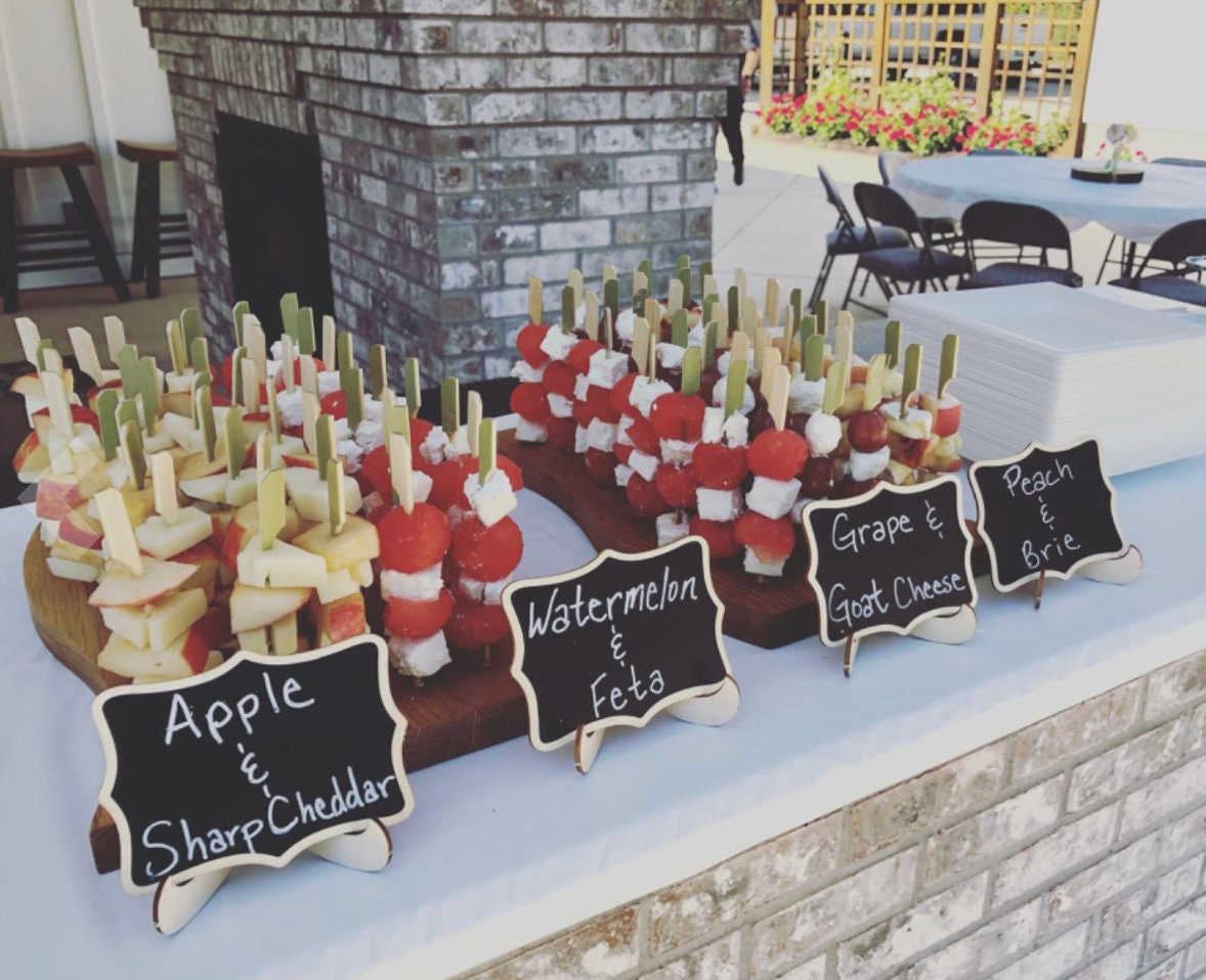 Outdoor charcuterie spread with bamboo and charcuterie toothpicks in fruit and cheese