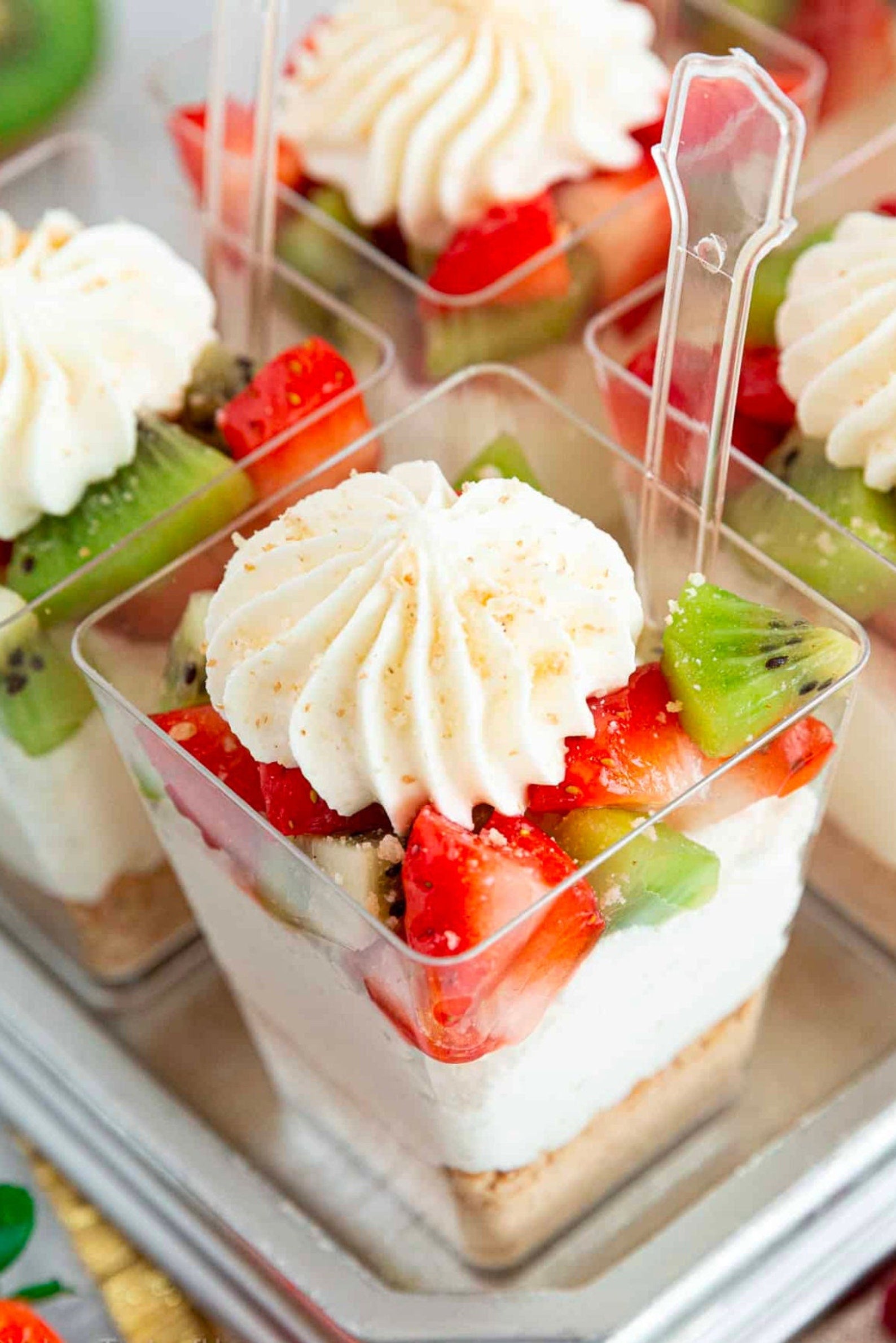 Berry parfait cups with lids arranged on dessert table display