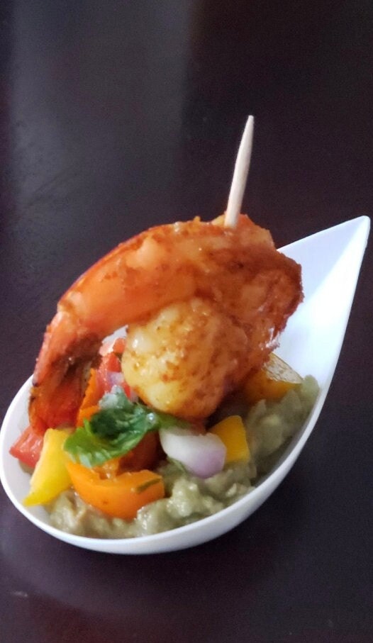Black Asian soup spoon with fried seafood.