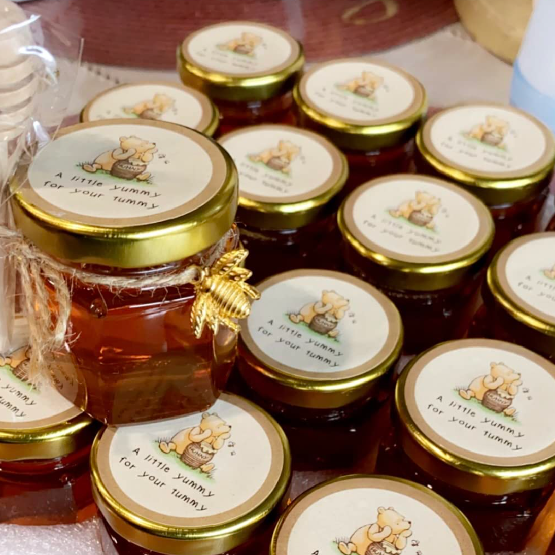 Rustic-inspired mini honey jars displayed at a bridal shower table.