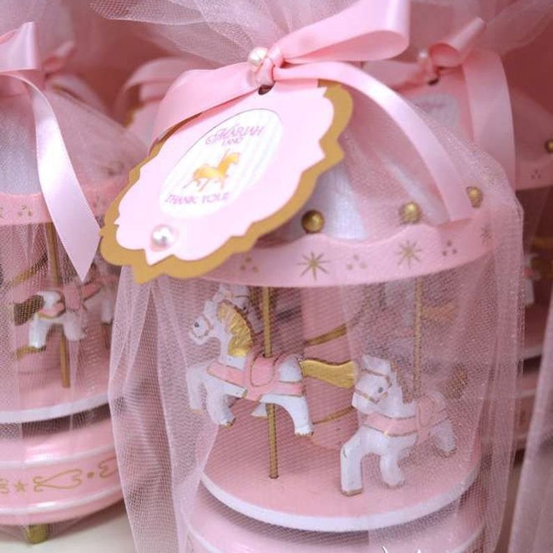 Carnival-themed cake with carousel horse topper spinning