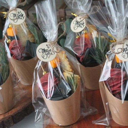 Brown charcuterie favor cups displayed on a wedding grazing table.