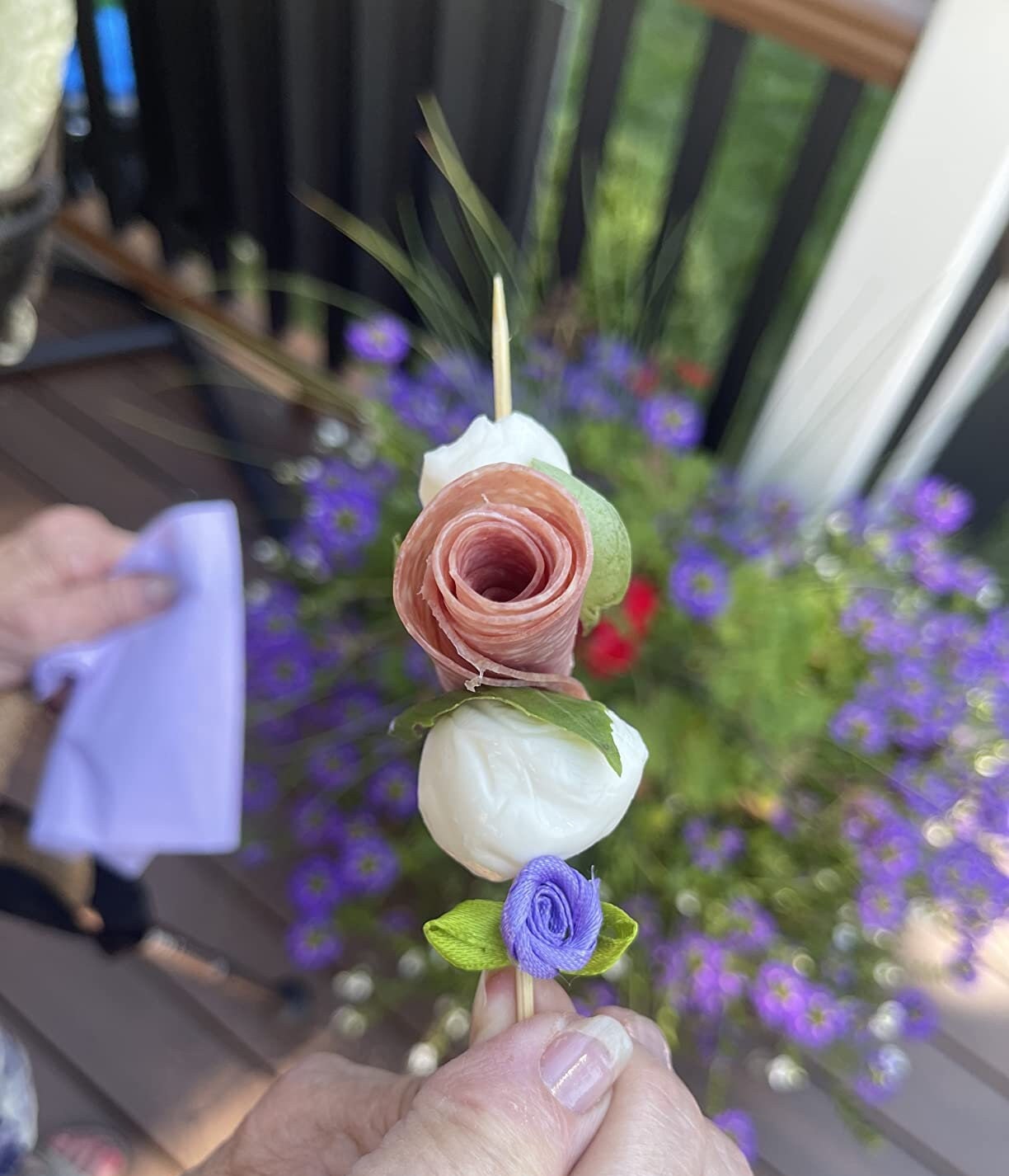 Rose charcuterie toothpick skewering meats and cheese