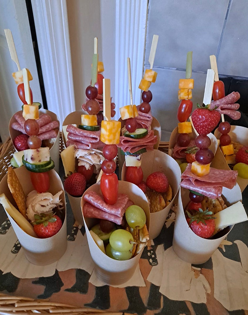 Charcuterie cups styled with charcuterie toothpicks holding meat and cheese