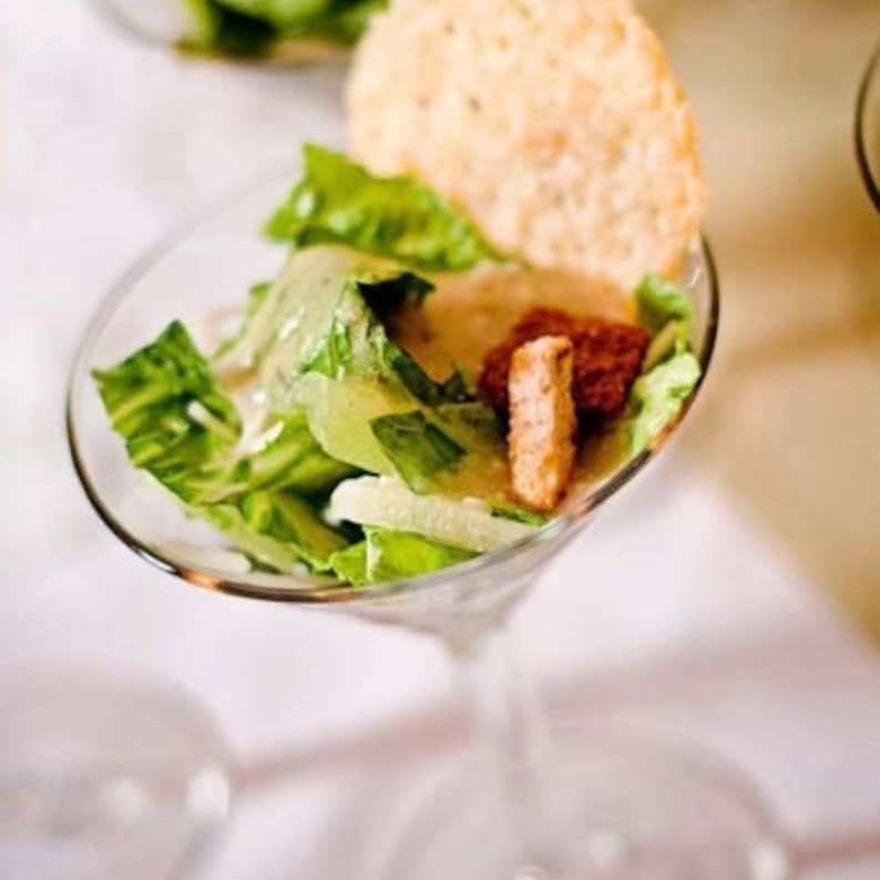 Close-up of salad served in acrylic appetizer cups with forks