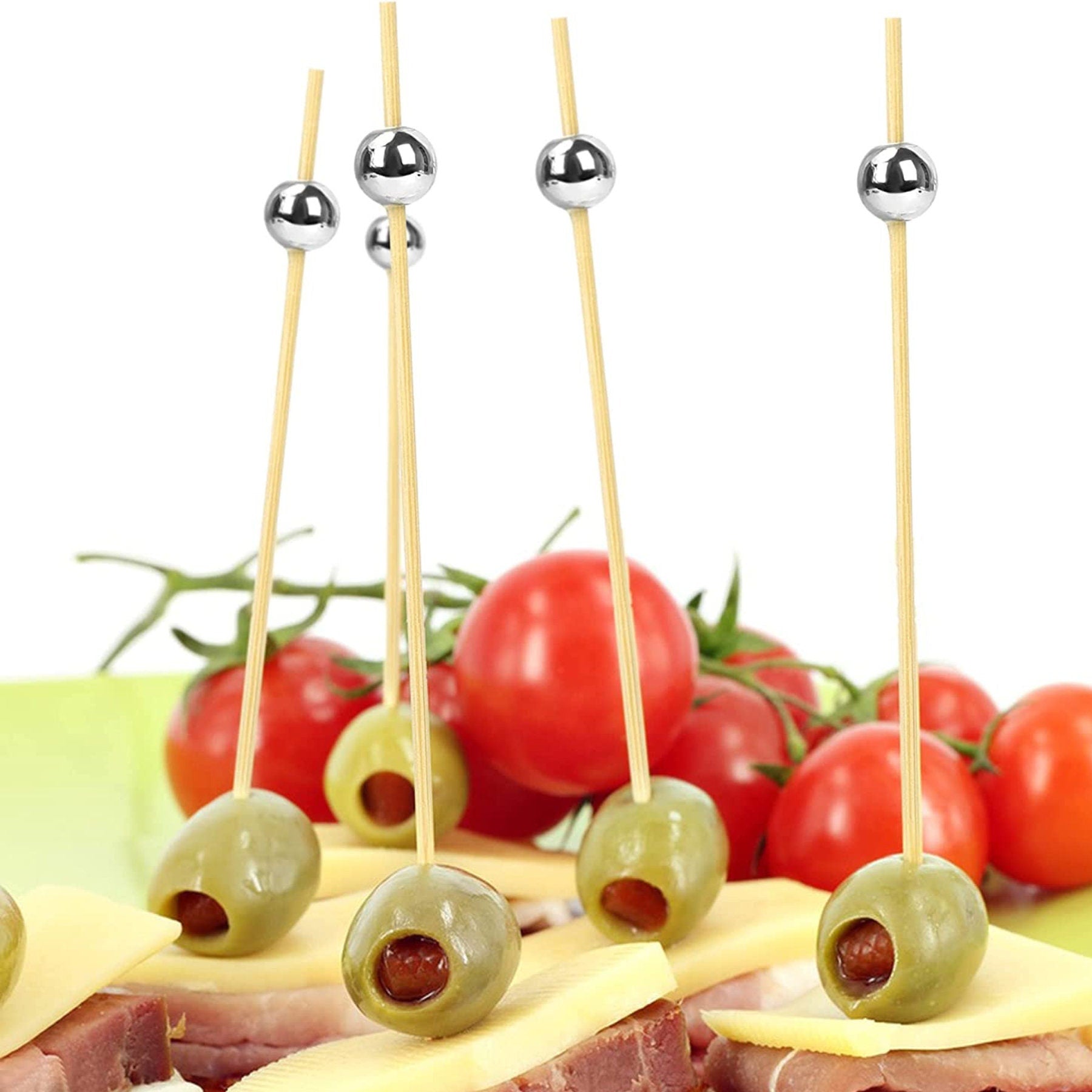 Close-up olive and cheese appetizer skewered with silver toothpick