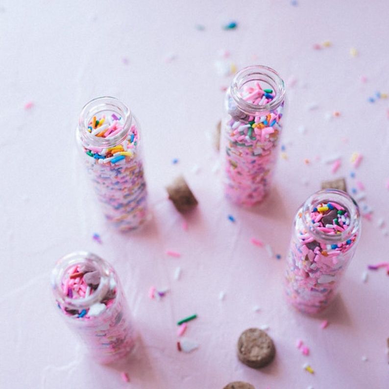 Sprinkle bottle favors with cork stoppers and twine accents.