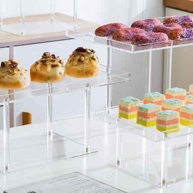 Crystal-clear acrylic cake stands arranged for wedding dessert table setup