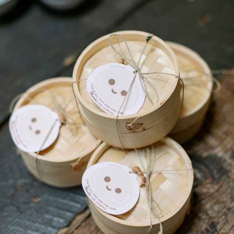 Cute bento boxes arranged for Asian themed party display with wooden forks and traditional chopsticks included.