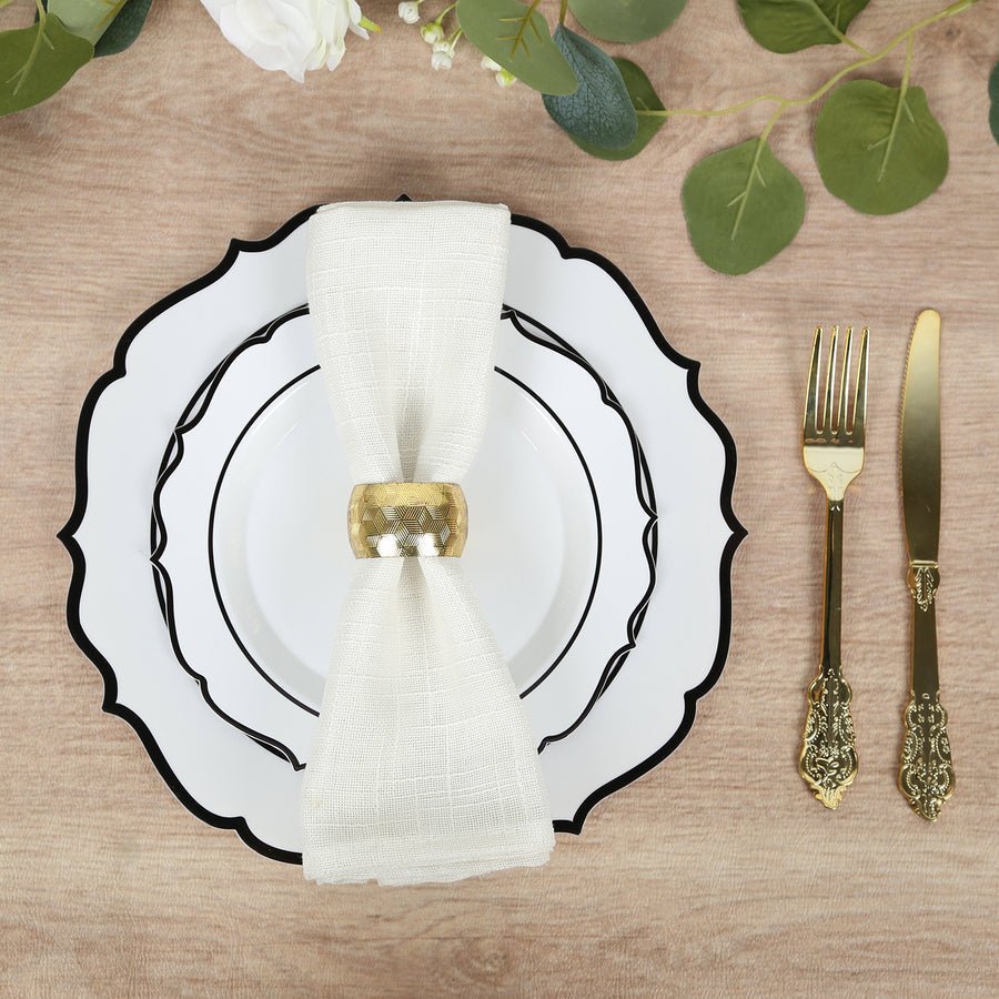 Black-rimmed white plates with gold cutlery and napkin – luxury disposable wedding dinnerware