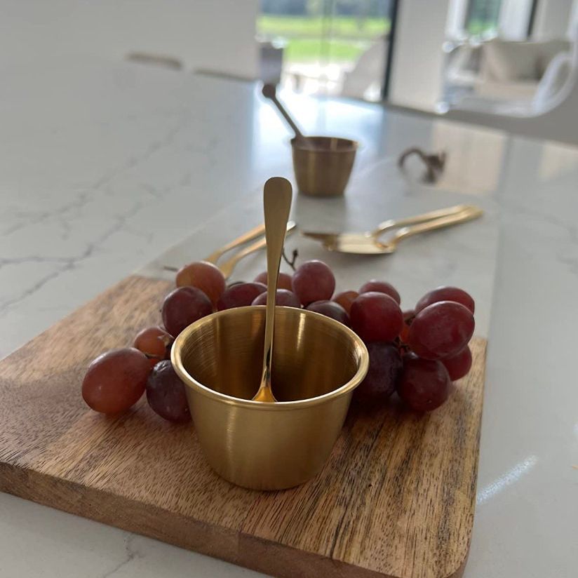 Charcuterie tool set with stainless steel dessert forks and spoons displayed on a grazing table.