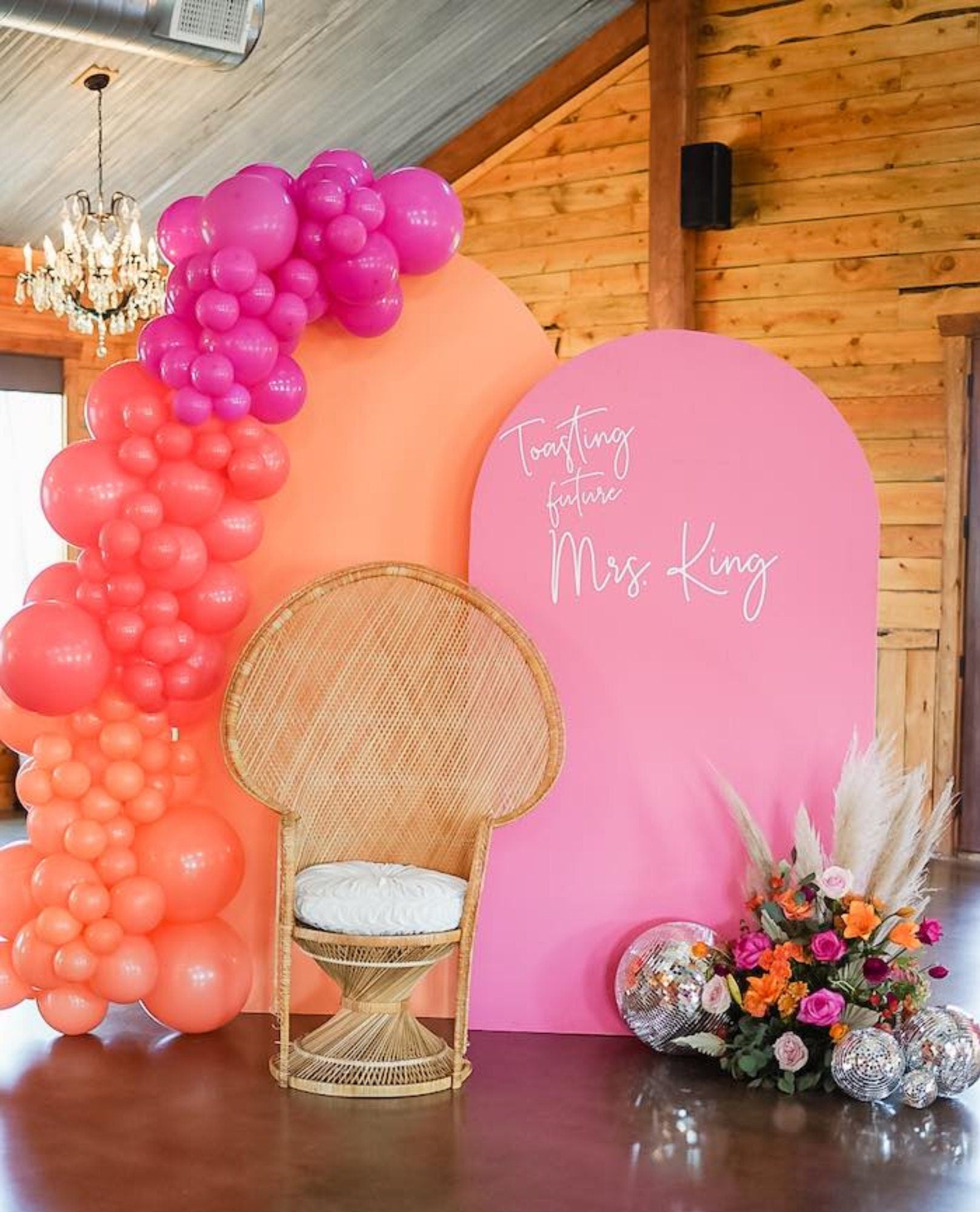 Disco balls styled with balloon arch and backdrop for party décor