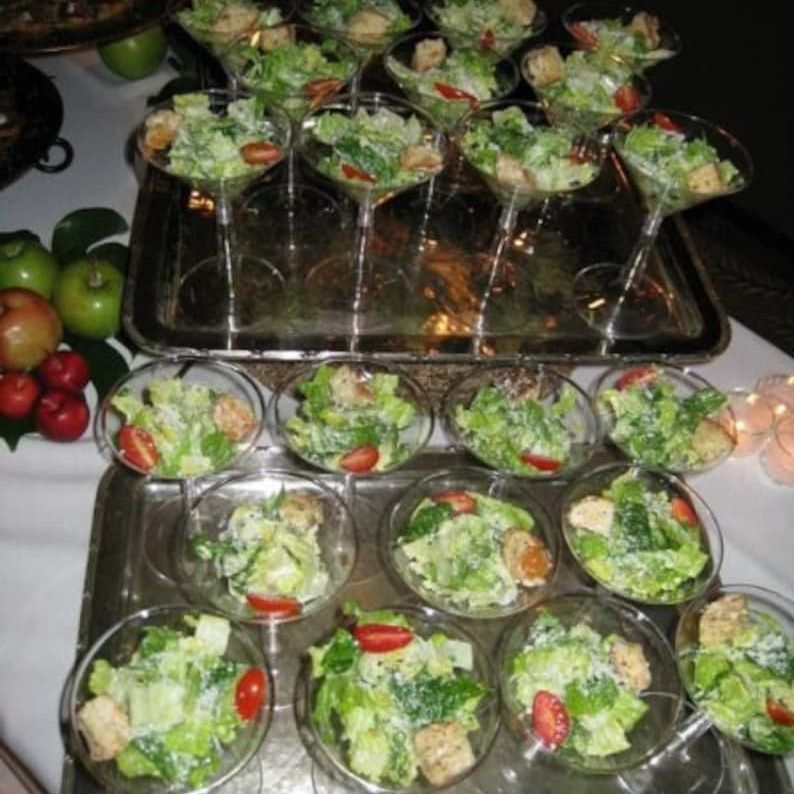 Acrylic salad cups filled with fresh greens, cheese, and toppings