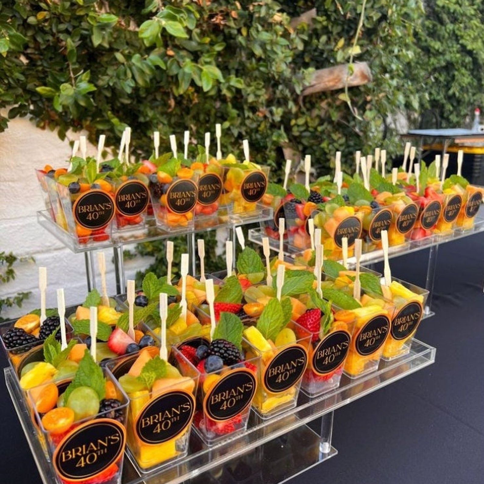 Elegant charcuterie cups set with mini fork displayed on event table.