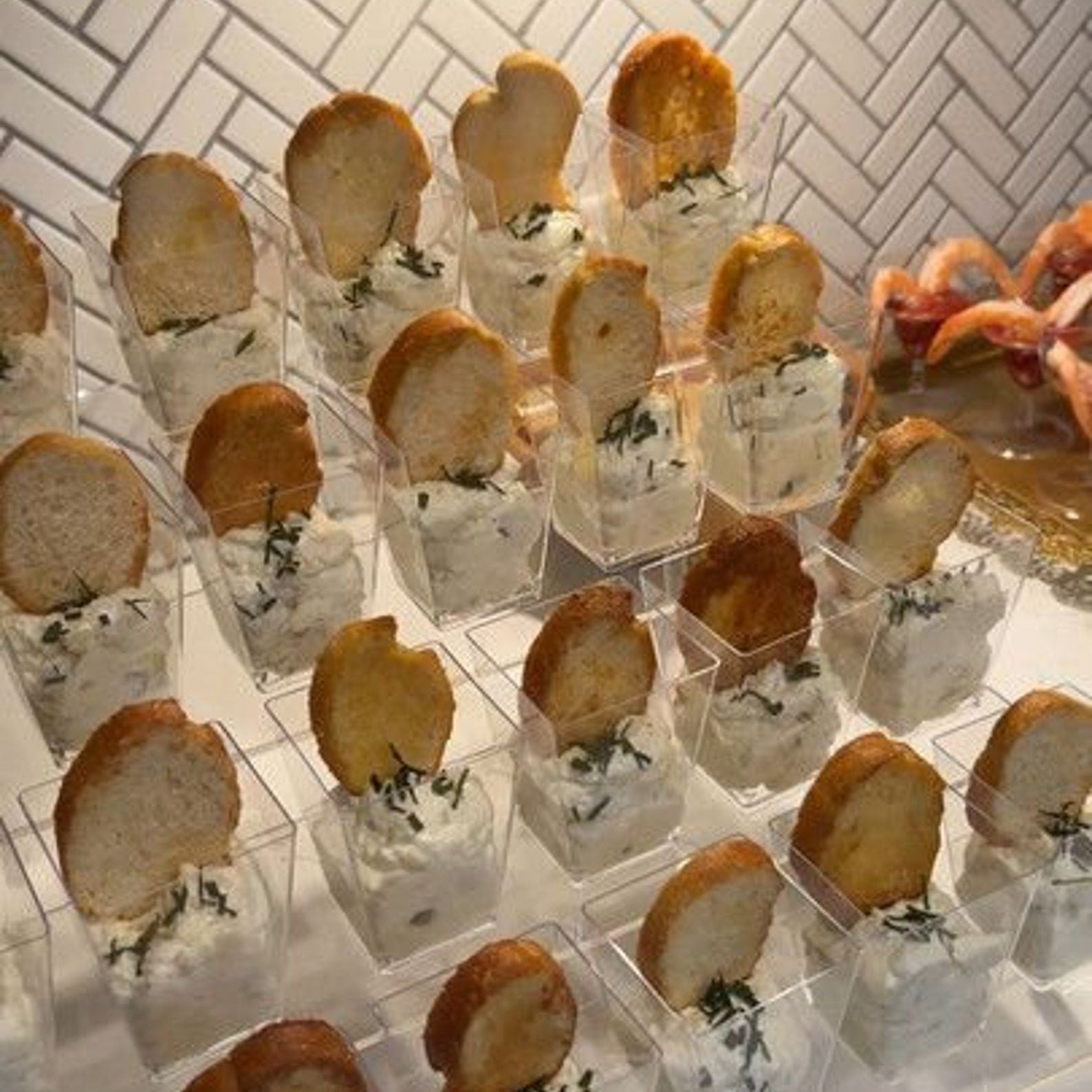 Fully arranged event table using charcuterie serving cups.