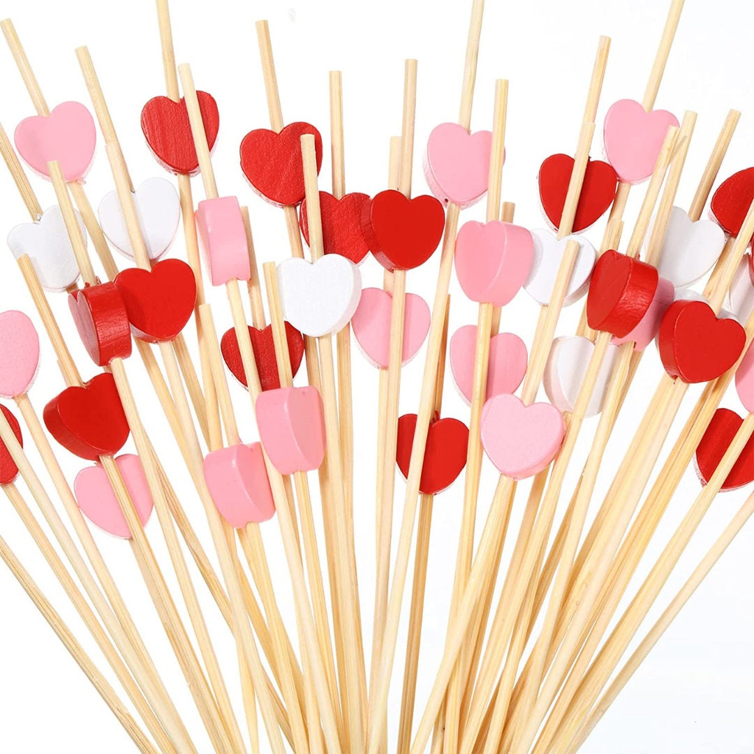 Close-up of pink heart-shaped fancy toothpicks.