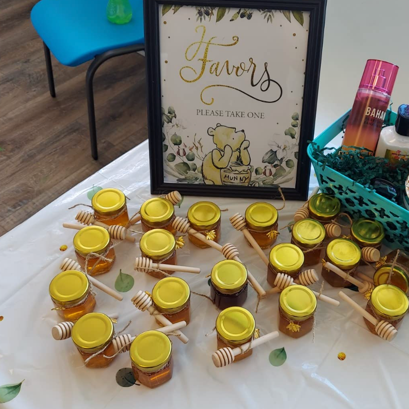 Mini honey jars and dippers creatively placed on a table.