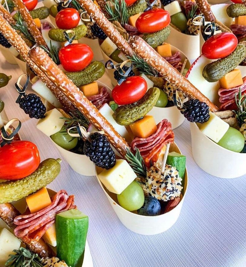 Grazing table with bamboo charcuterie cups filled with assorted snacks