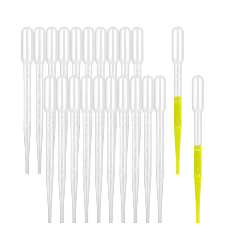 Grazing table setup featuring acrylic charcuterie cups with pipettes and forks.