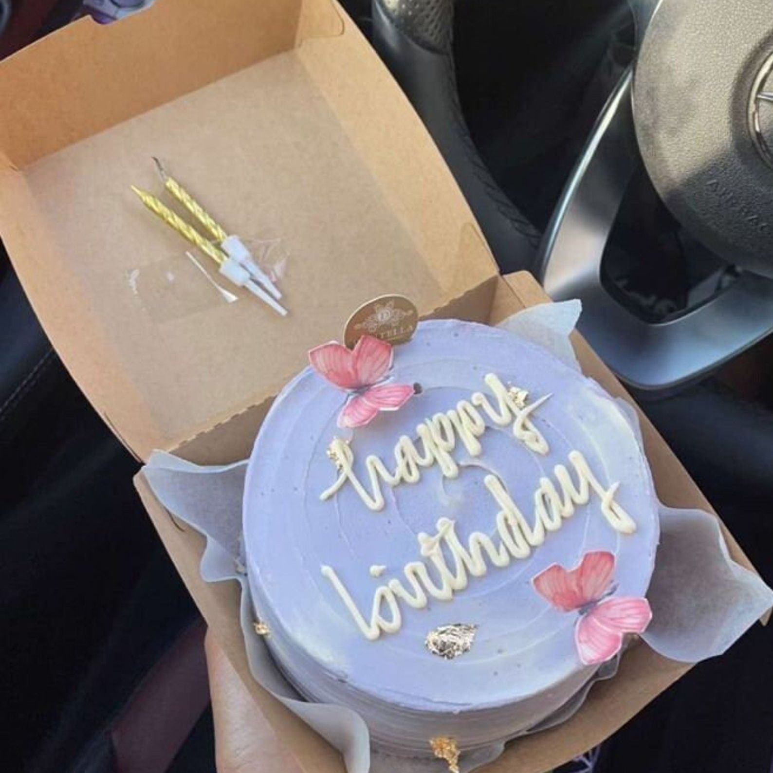 Round cake with "Happy Birthday" inside of a cake gift box.