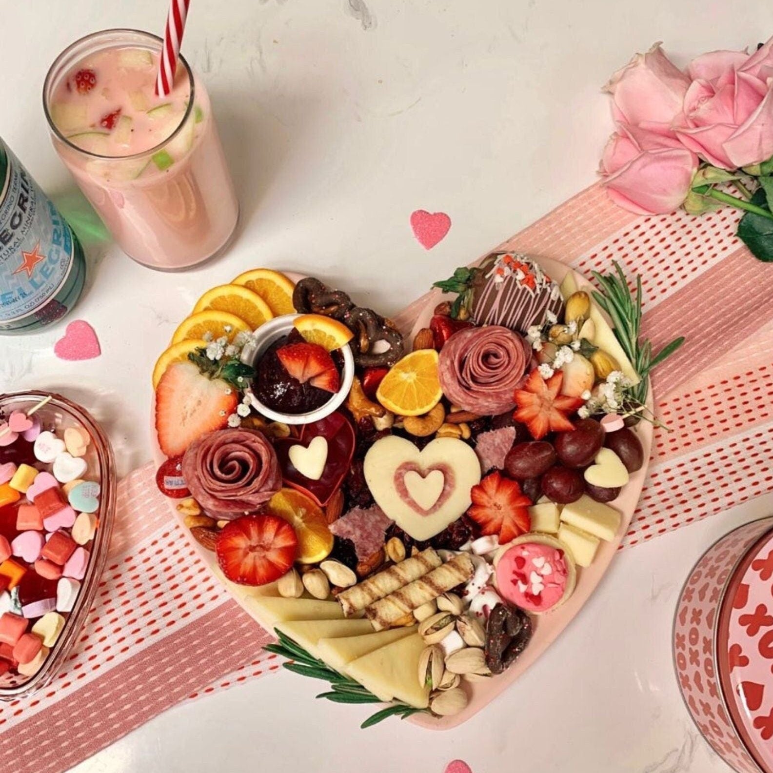 Heart-shaped bamboo charcuterie board with cheese and fruits