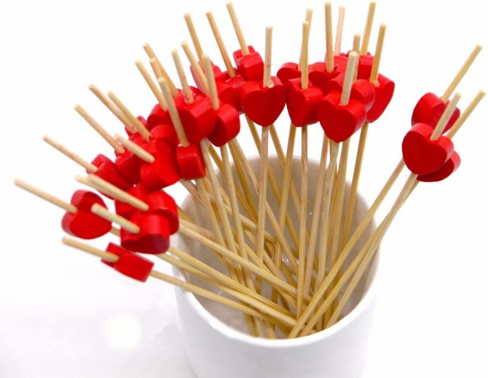 Heart-shaped bamboo appetizer toothpicks displayed in cup for charcuterie