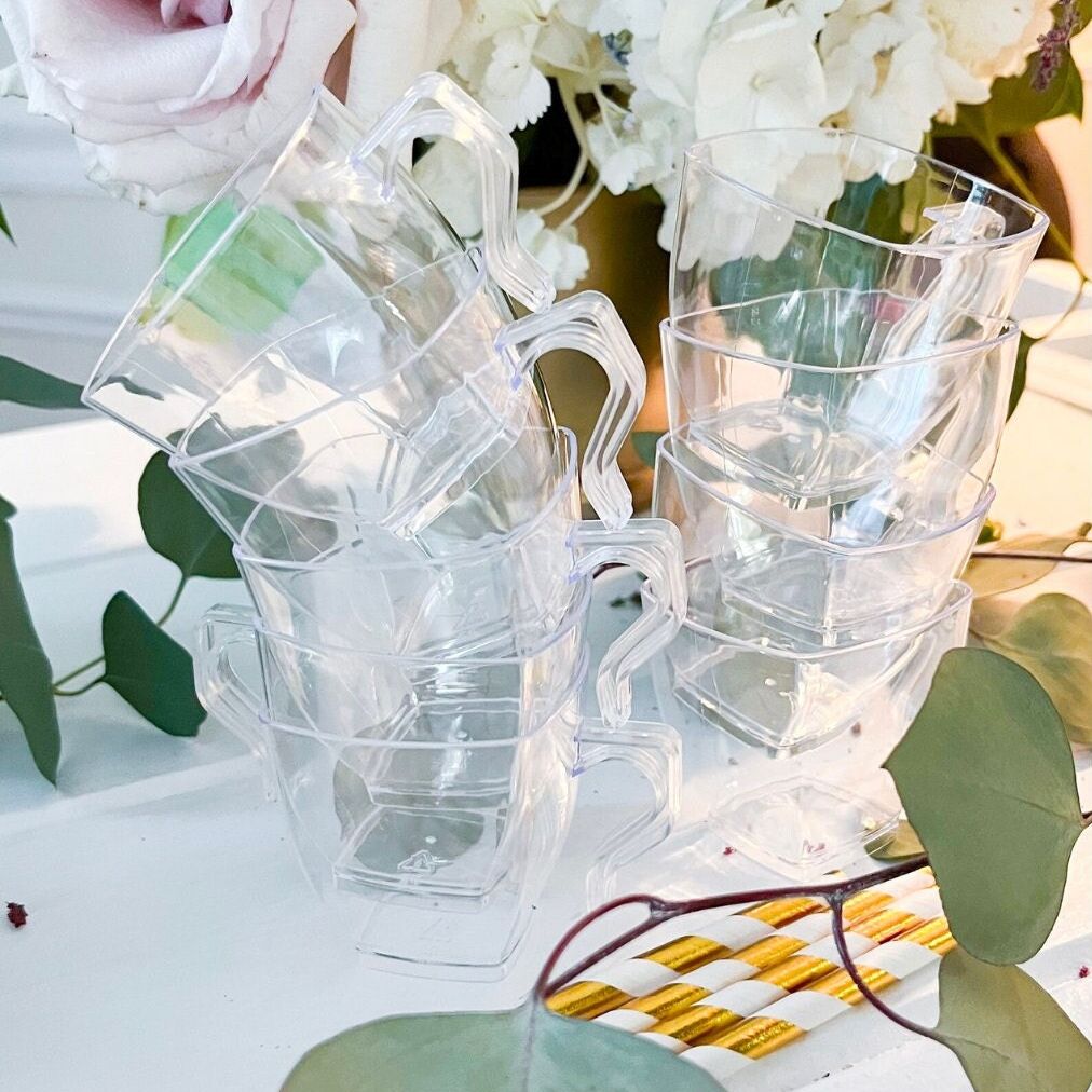 Acrylic mugs with hot cocoa and marshmallows styled for a party