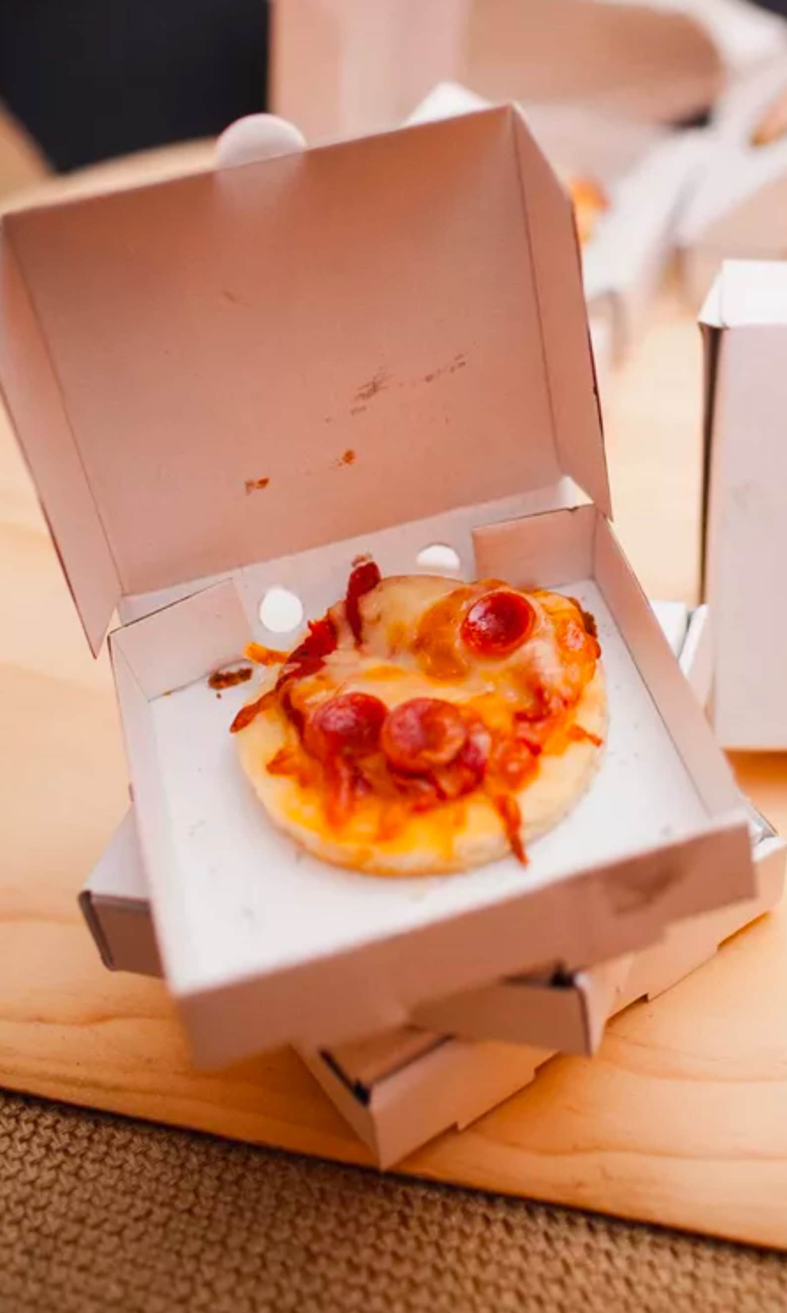 Tiny pizza boxes filled with snacks for a kids’ pizza party.