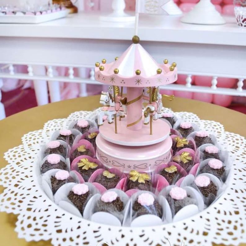 LED-lit carousel cake topper spinning on a party table