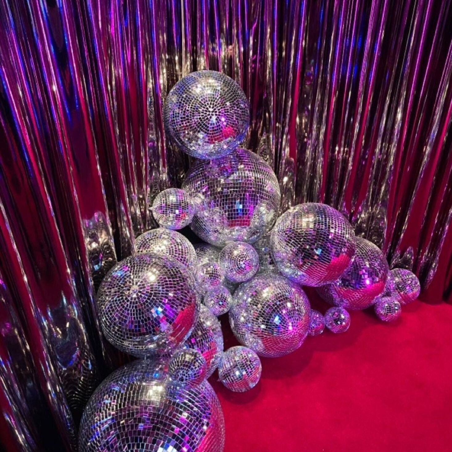 Glamorous display of decorative disco balls on a table, ideal for birthday party supplies.