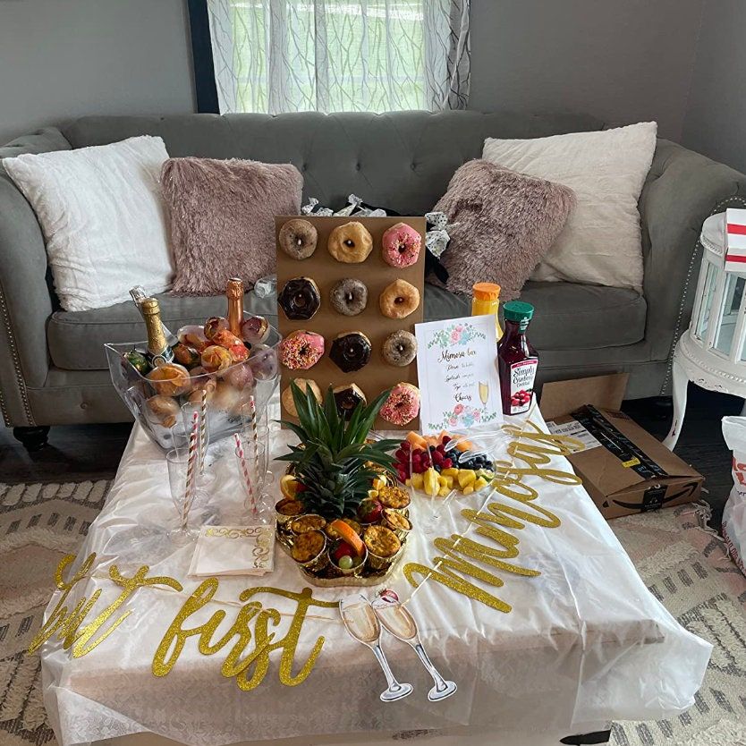 Juice carafes and straws with mimosa bar sign styled for baby shower or brunch