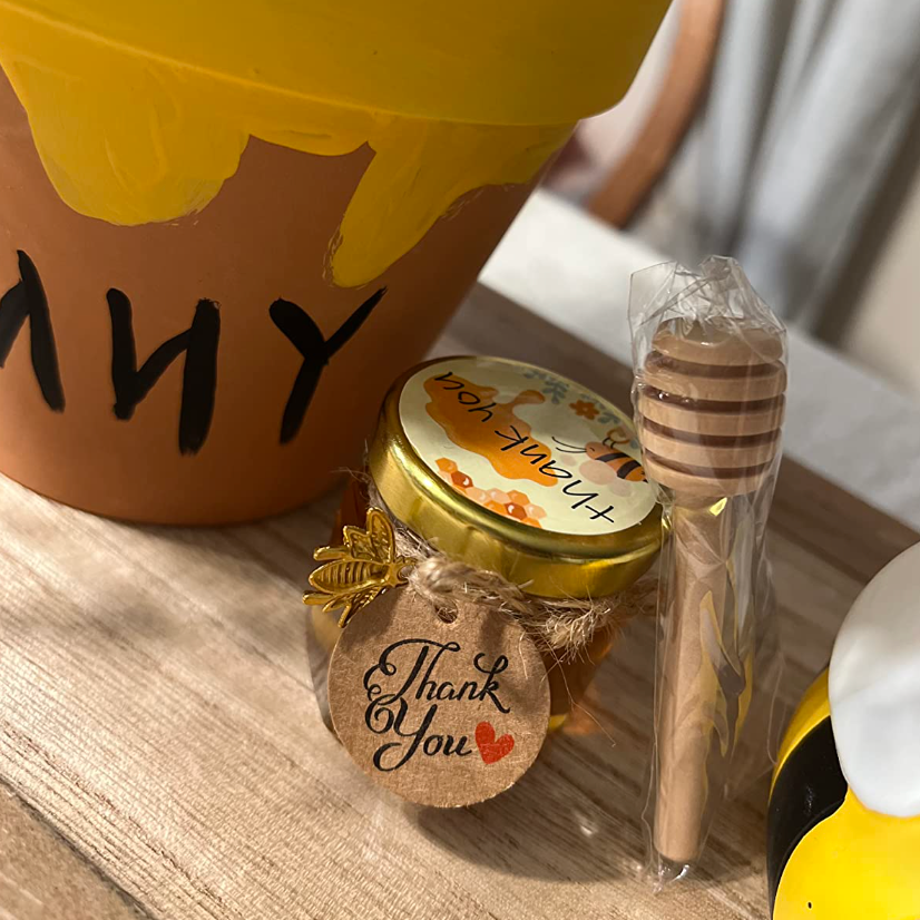 Mini honey jars tied intricately with twine.
