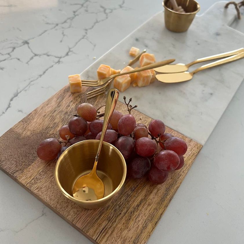 Mini toothpick flags and stainless steel utensils from the 22-piece charcuterie tool set.