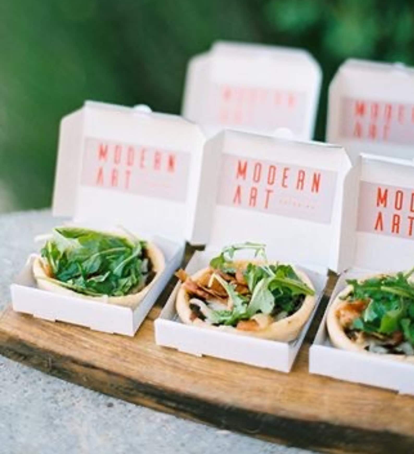 Mini pizza boxes filled with candies at a vibrant birthday party.
