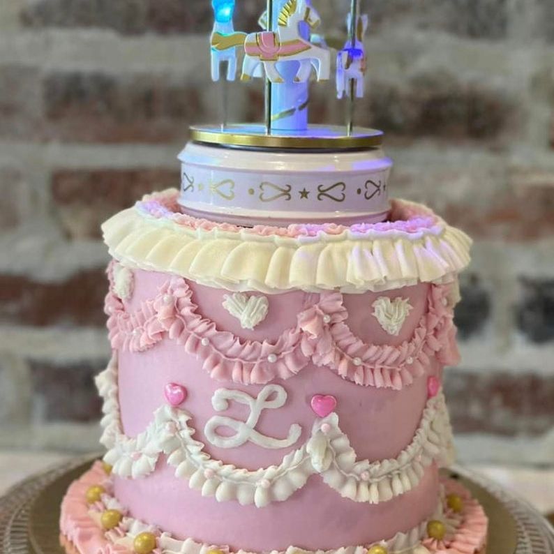 Musical spinning carousel cake topper with colorful LED lights