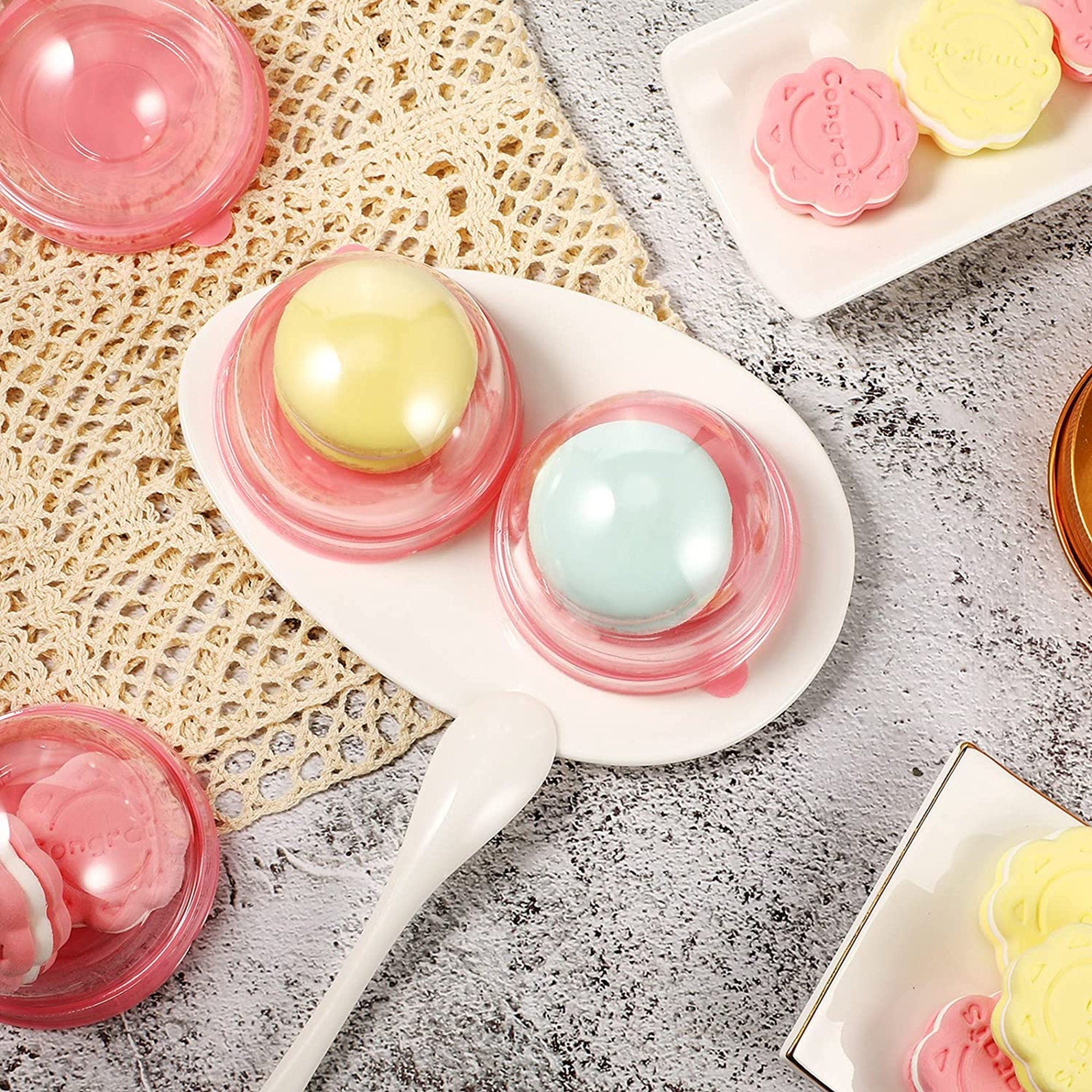 Pink dome macaroon boxes displayed on a lace mat, perfect for showcasing macarons in clear favor boxes.
