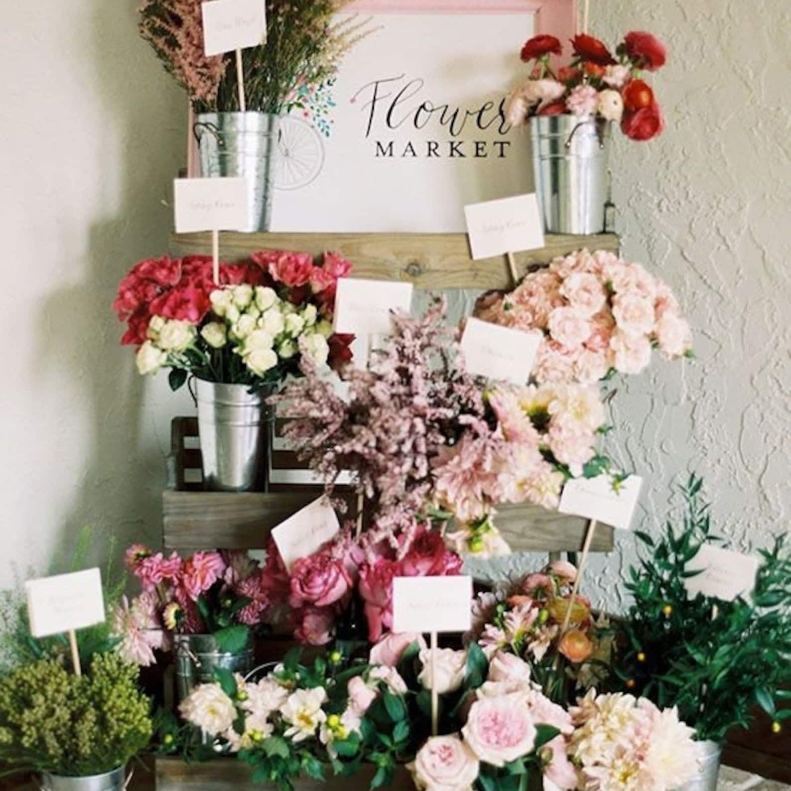 Pre-cut floral wrapping paper sheets, ideal for wrapping bouquets at a bridal shower flower bar.