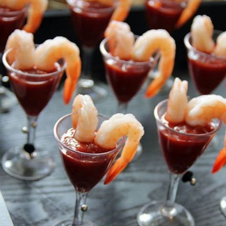 Shrimp cocktail glasses displayed with mini wooden forks, showcasing their elegant design for serving appetizers and desserts.