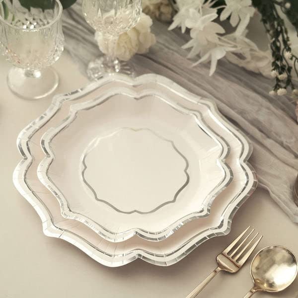 Set of gold and silver scallop rim party plates arranged for catering event